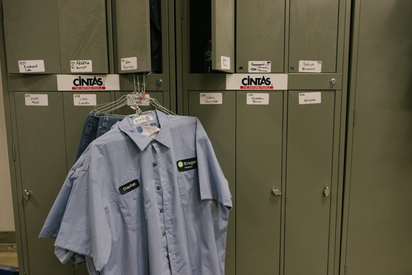 A row of employee lockers with uniform shirts. (Brandon Dahlberg)