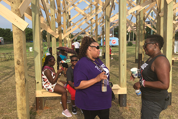 Resident Felicia A. Miller and Uptown coordinator Tanja Mitchell chat in front of Treedom Memphis at the June 2nd kickoff event. (Cole Bradley)