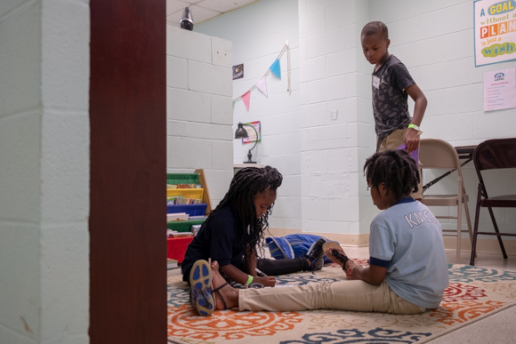 Several elementray school students work on homework after school at Oasis of Hope. (Brandon Dahlberg)