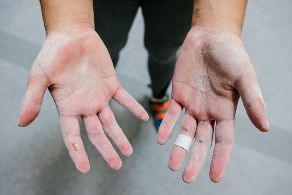 Caye Caparas shows her chalk covered hands from a recent ascent on one of the bouldering walls at Memphis Rox. This was her first time at the facility. (Brandon Dahlberg)