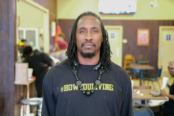 Mente', owner of Smooth Living, poses for a portrait in his cafe. (Brandon Dahlberg)