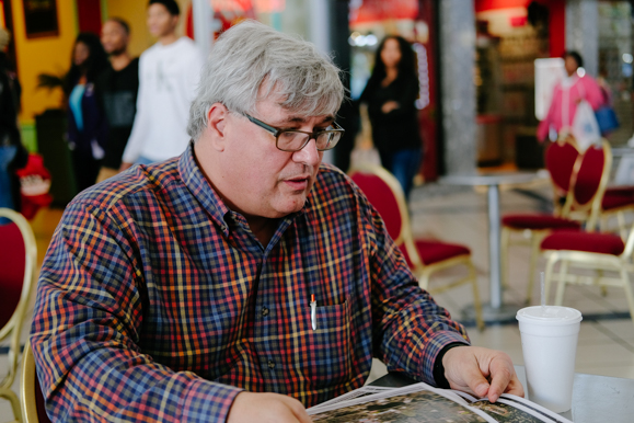 Shawn Massey, partner with The Shopping Center Groups, reviews maps of Whitehaven at the Southland Mall. (Brandon Dahlberg)