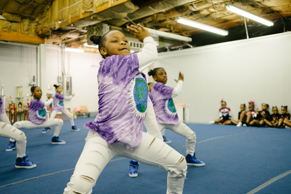 The Memphis Area Youth Association minis group, which is made up of people in the 4th grade and under, practice a cheer routine. (Brandon Dahlberg)