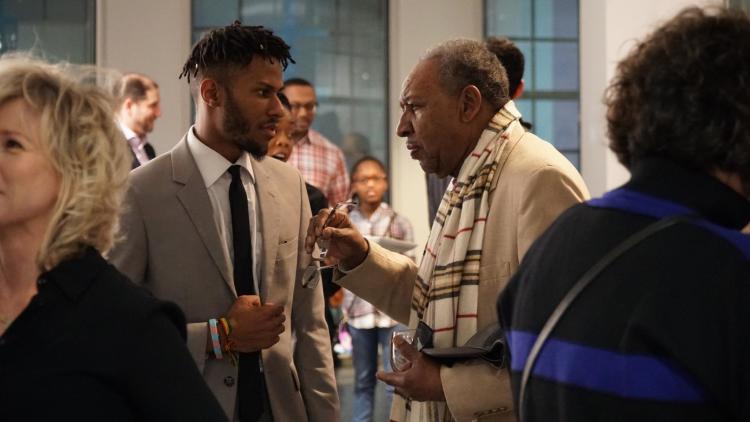 Multimedia artist Lawrence Matthews of The CLTV talks with Dr. David Acey, professor of African-American rhetoric and creator of Africa in April at an exhibition opening for Black Resistance, hosted by The Brooks and programmed by The CLTV. (Ashley Bend)
