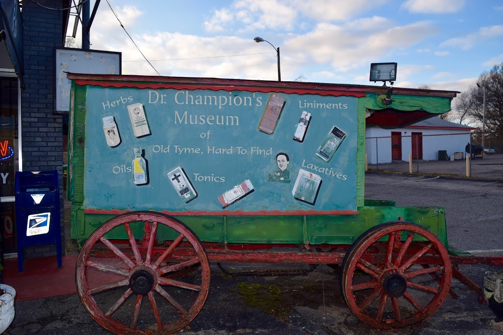 A wooden medicine wagon advertises “Dr. Champion’s Museum of Old Tyme, Hard to Find Tonics". (Rachel Warren)