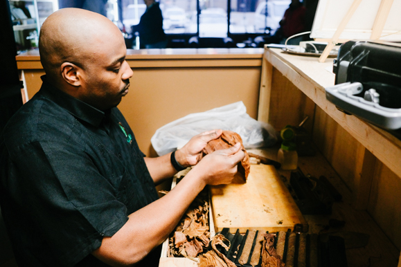 Jason Gardner demonstrates his cigar rolling process. He and his brother, Antonio, studied these techniques in Cuba. (Brandon Dahlberg)