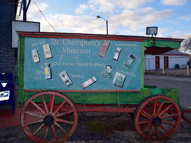 A wooden medicine wagon advertises "Dr. Champion's Museum of Old Tyme, Hard to Find Tonics" in 2017.