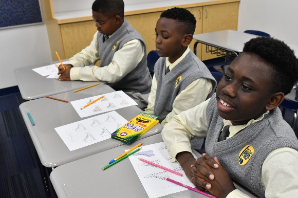 Grizzlies Prep 7th graders Nigel Pruitt, Kylan Fullilove and Michael Webb brainstorm ideas for designing shoes to go along with their individual brands that they've been establishing throughout the semester as part of a Creative Works course.