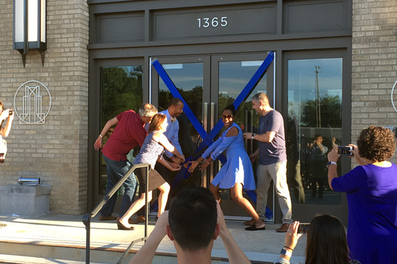 Chris Terrill, far right, and other Crosstown High board members cut the ribbon to Midtown's new high school.