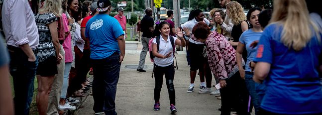 Students at Kingsbury Middle School are greeted on the first day of school by community members showing support after weeks of ICE raids on the Latino community.