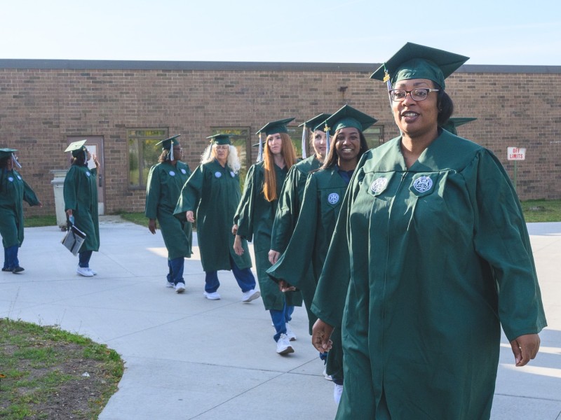 The inaugural class of EMU's College in Prison program heads to their graduation, led by class speaker Katherine Woods.