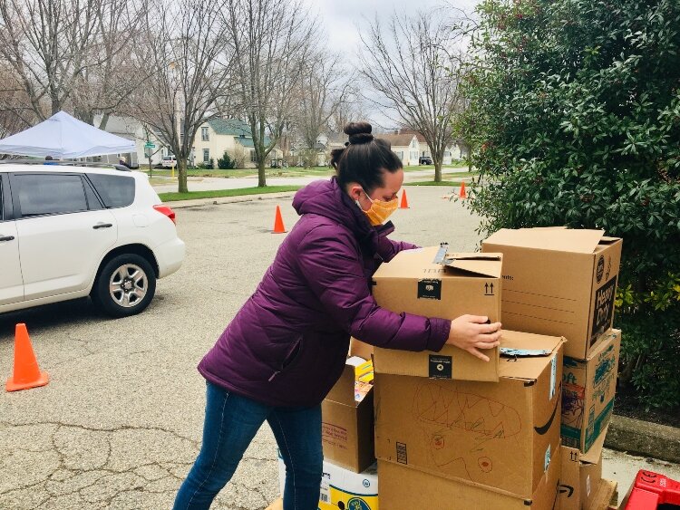 Chara Bouma-Prediger, a CAH staff member in the Food Pantry and Resource Connection team, gathers donated food.