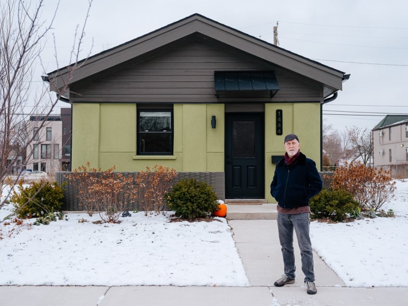 Tom Woodman stands in front of a 3D-printed home in Detroit created by his company, Citizen Robotics, which is planning two developments in Pontiac. The company aims to reduce construction costs at scale and create a new renting model that gives renters equity in a housing fund.